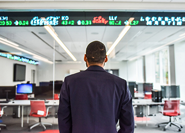 back of student who is looking at the stock ticker